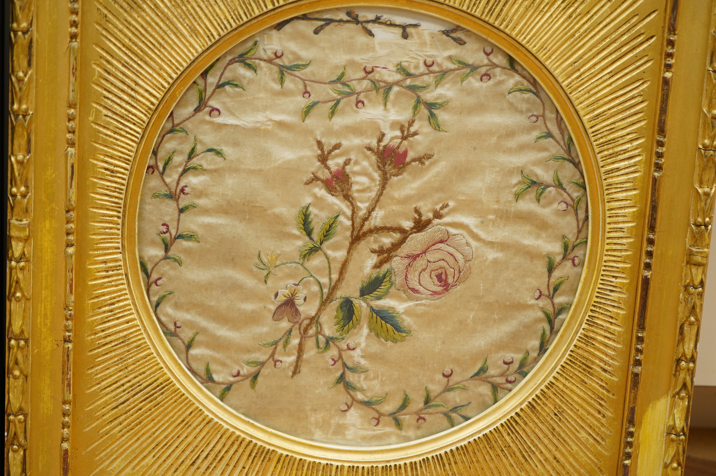 A late 18th century polychrome floral silk work embroidery of a cornucopia of flowers and a butterfly above, dated 1770, together with an early 19th century embroidery of a spray of roses surrounded by a floral border, w